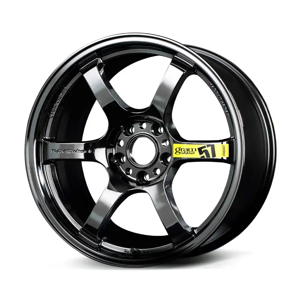 A dark gray, six-spoke car wheel with a glossy finish.