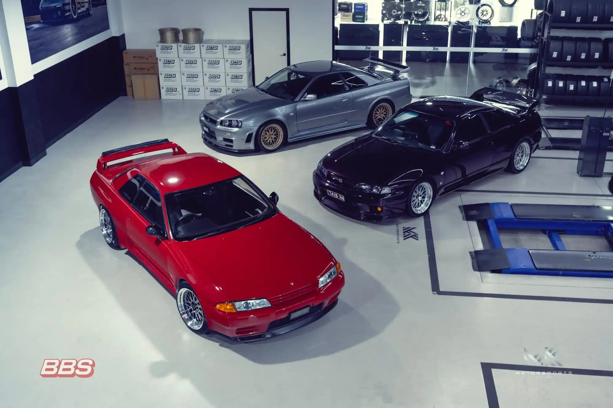 Three performance sports cars parked in a garage.