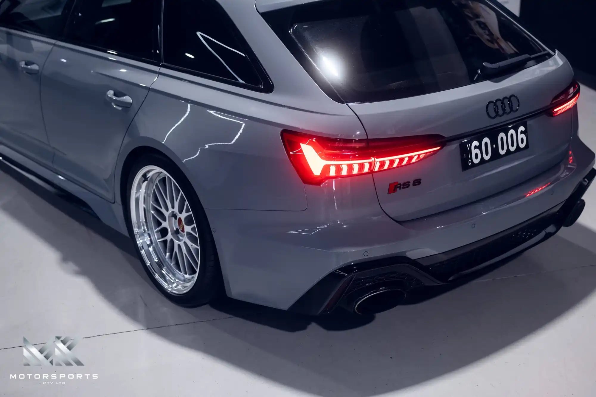 Sleek gray Audi RS 6 Avant with custom aftermarket wheels and a sporty rear diffuser.