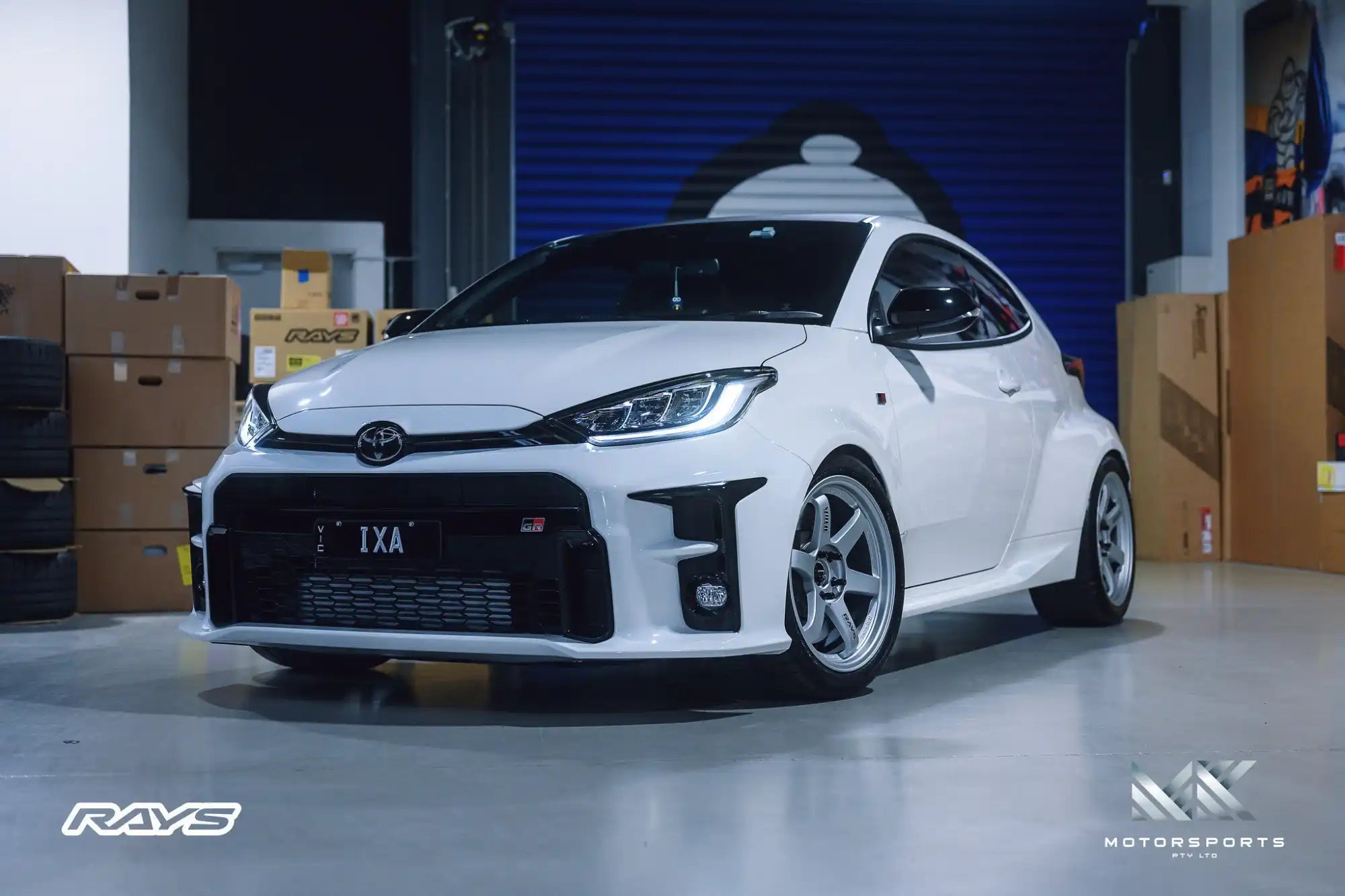 White 2020+ Toyota GR Yaris with aftermarket silver multi-spoke wheels.