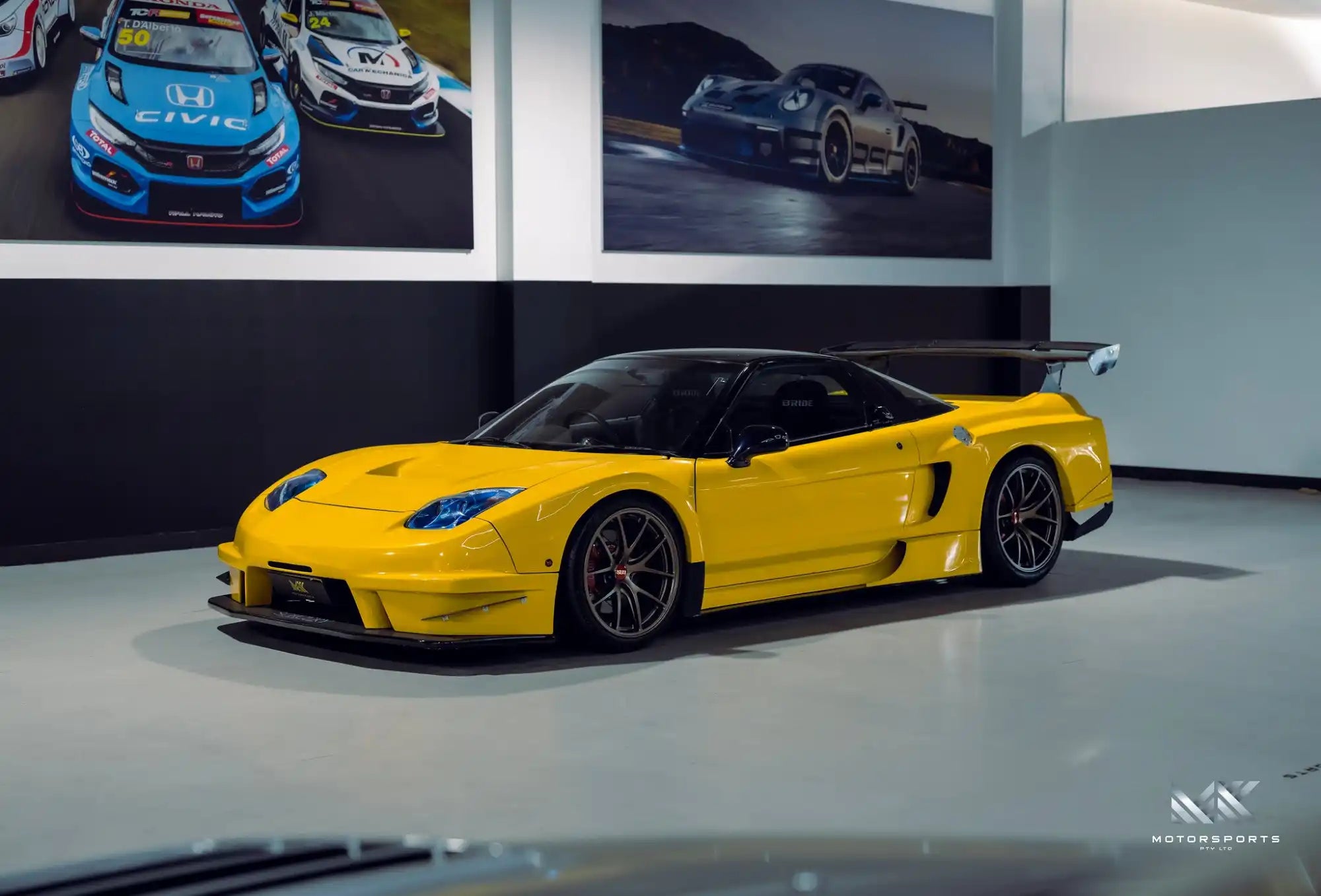 Yellow sports car with a large rear wing.